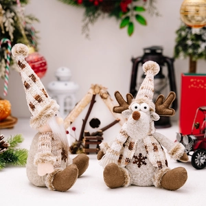 Detail of plush Christmas gnome and reindeer dolls with cozy knitted textures and faux fur