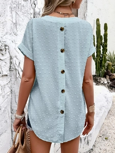Detail of light blue short sleeve V-neck top with polka dot texture and back button design