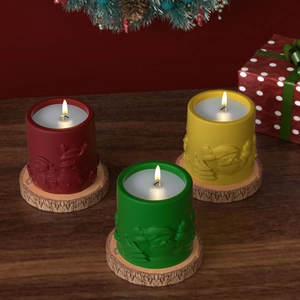 Three Christmas candles with Santa and reindeer relief on a warm wooden table