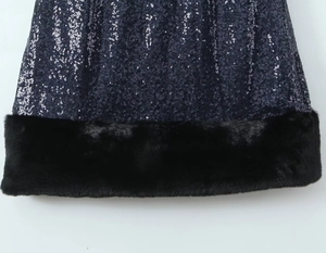 Close-up of the silver sequin dress hem with premium black faux fur trim detail
