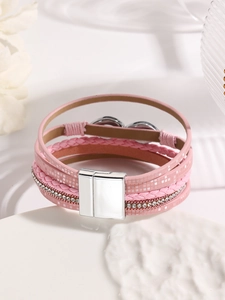 Close-up of pink multilayer leather bracelet featuring sparkling rhinestones and magnetic clasp