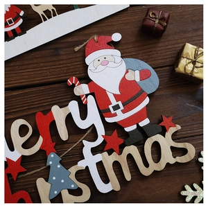 Close-up of Merry Christmas wooden hollow sign with Santa Claus for tree decoration