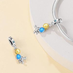 Astronaut charm bead in silver with blue star ring and yellow enamel space traveler pendant