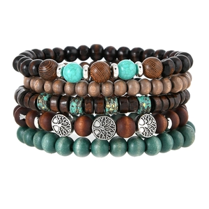 Detail of five-layer stacked wooden bead bracelets featuring Tree of Life metal charms