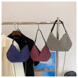 Three rhinestone hobo bags in blue, pink, and silver with elegant chain straps