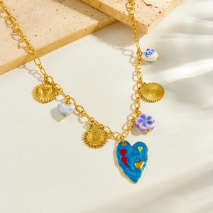 Gold stainless steel necklace with colorful enamel heart and ceramic flower pendants