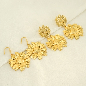 Detailed macro view of gold sunflower earrings showing petal textures and floral centers
