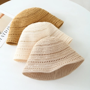 Detailed crochet hollow wave pattern on summer sun hats in caramel, cream, and beige colors