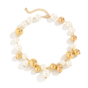 Close-up of large faux pearls and gold alloy spheres necklace with a lobster clasp