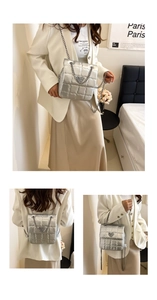 Detail of silver quilted chain bag with heart buckle shown in multi-angle lifestyle shots