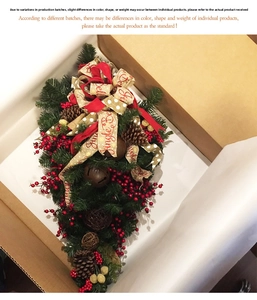 Detail of Christmas teardrop swag with red berries and jingle bells in packaging