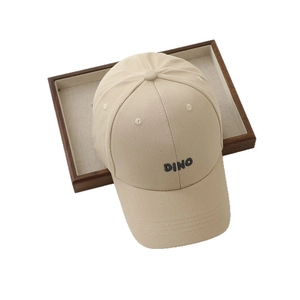Minimalist beige baseball cap with DINO letter embroidery for kids on wooden tray