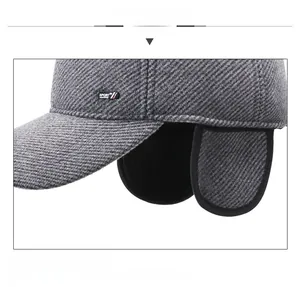 Close-up of gray knit winter cap showing warm ear flaps and textured twill fabric