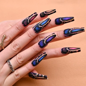 Macro detail of long coffin nails with dark snake pattern and iridescent scales