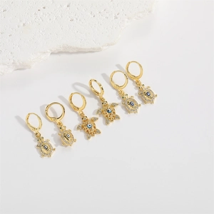 Set of six gold turtle hoop earrings with blue evil eye charms and sparkling zircon stones