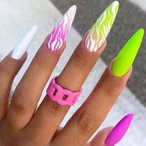 Macro view of long stiletto press-on nails with zebra pattern and neon gradient finish