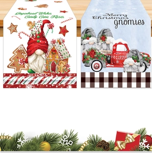 Detail of Christmas table runner with gingerbread house and gnome patterns on wood background
