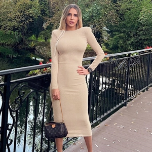 Detail view of beige long-sleeved midi dress with padded shoulders and slim fit cut