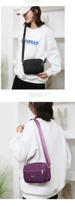 Detail showing black and purple quilted crossbody bags with gold metal JINGPIN logo