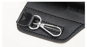 Close-up of black lychee leather phone holster with silver metal rotating lobster clasp