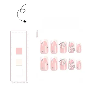 Detail of French tip press-on nails with 3D silver butterflies and sparkling rhinestones