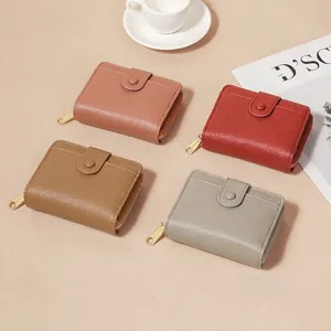Litchi pattern women's short wallet in pink, red, and brown with gold zipper closure