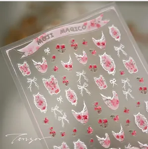 Detail of floral nail art stickers featuring pink roses and bow designs in French style