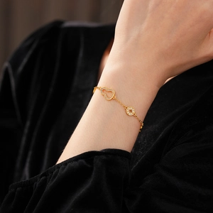 Detail of 24k gold-plated gourd bracelet with pavé white zircons on a female wrist