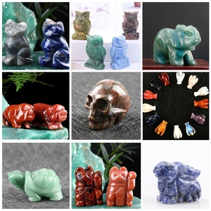 Macro display of diverse hand-carved gemstone animal figurines in polished vibrant minerals