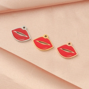 Red lip charm pendants in gold, silver and rose gold on pink silk background