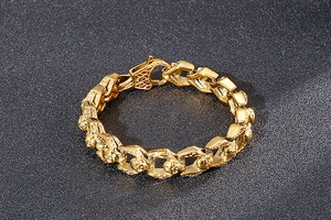 Macro shot of gold skull links on a hip hop style titanium steel bracelet detail