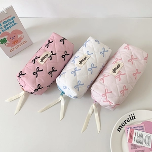Quilted bow makeup bag collection in pink and white with smooth zipper and ribbon detail