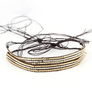 Macro detail of multi-strand braided jute rope with gold and silver metallic beads