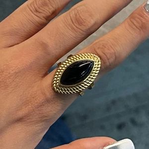 Detailed view of an 18k gold vintage ring with a marquise-cut black onyx stone