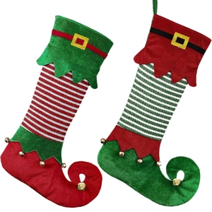 Christmas elf boot stockings with red and green stripes and golden bells on white backdrop