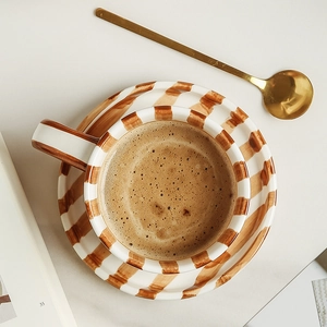 Japanese style hand-painted ceramic coffee cup and saucer set with brown stripes and gold spoon