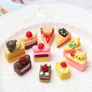 Macro shot of assorted colorful resin macaroon miniatures with cute cartoon designs