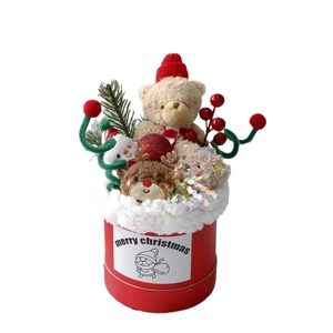Christmas plush bear and reindeer bouquet in red gift bucket with festive pine and berry decor