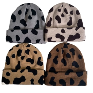 Detailed view of four assorted leopard print knit beanies in gray, beige, yellow, and brown