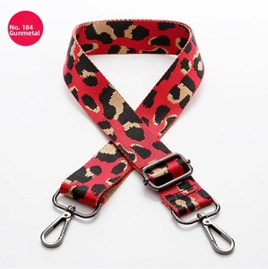 Detailed view of leopard print bag strap with gunmetal swivel hooks and adjustable buckle