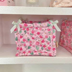 Detailed view of pink floral quilted storage basket with bow and soft texture