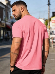 Outdoor back view of men's pink cotton T-shirt showing casual fit and soft fabric texture