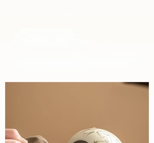 Detail showing high-quality ceramic tea canister with elegant green bamboo leaf painting