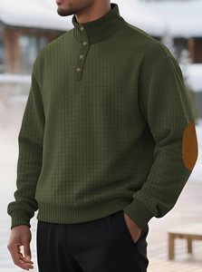 Detail of dark green waffle knit hoodie with brown elbow patches and buttoned collar