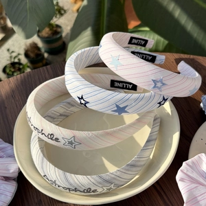 Padded striped headband with star embroidery and Astrophile text in multiple colors