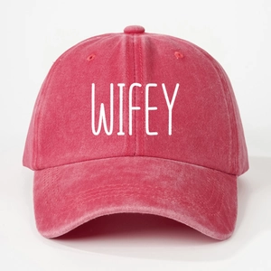 Detailed front view of washed cotton baseball cap with bold WIFEY print in deep red