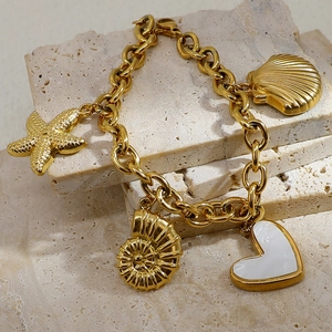 18K gold plated stainless steel bracelet with starfish and seashell charms on stone