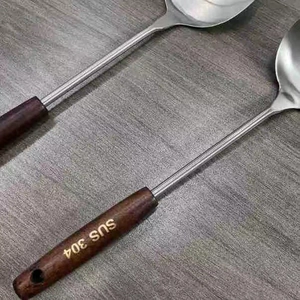 SUS 304 stainless steel spatula set with vintage heat-resistant wood handles on a table