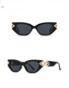 Front and 45-degree side views of black cat-eye sunglasses with gold metal accents