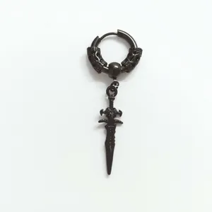 Macro shot of Gothic black stainless steel dragon ring and dagger pendant earring